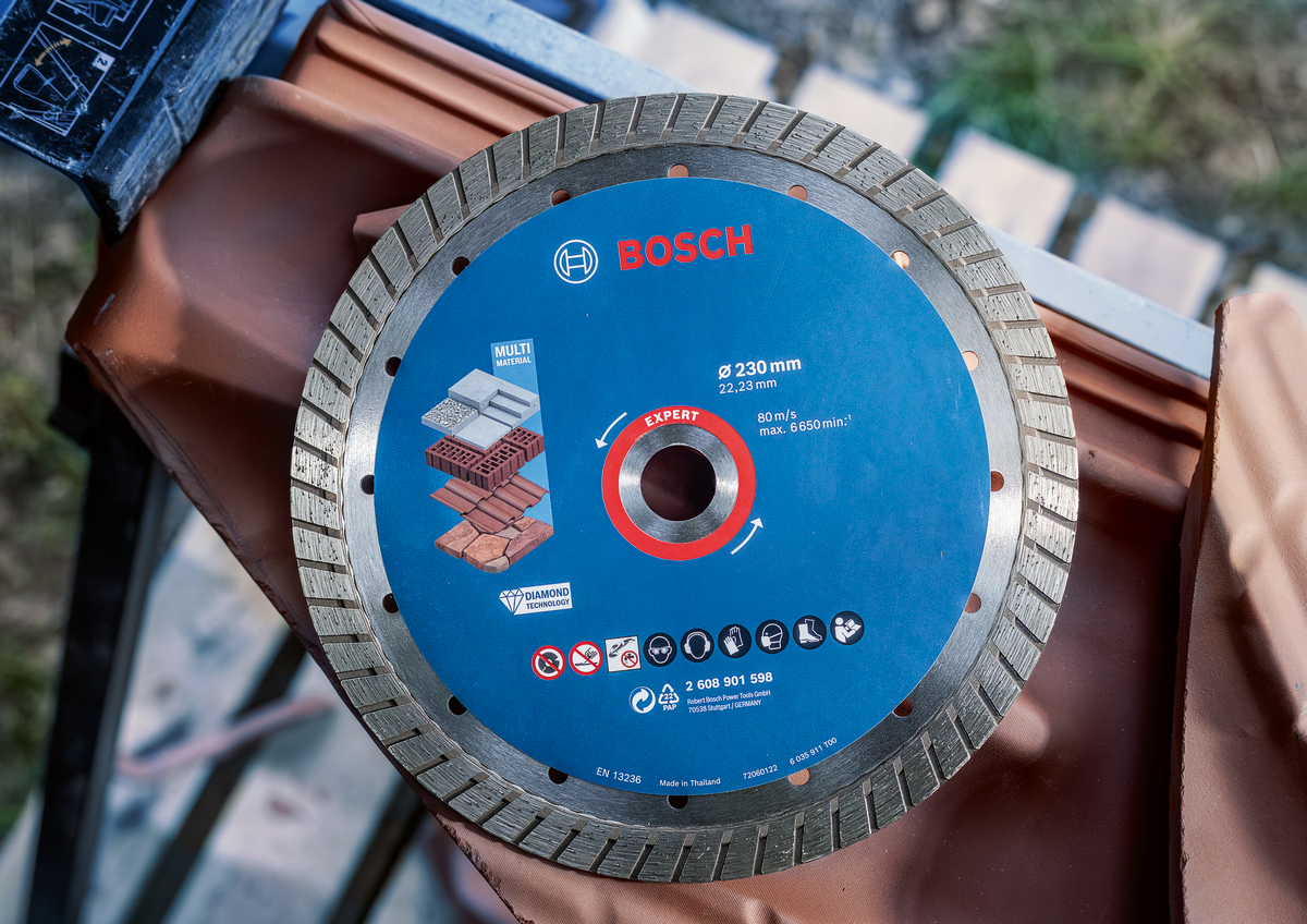 Bosch EXPERT MultiMaterial Diamond Cutting Disc 230mm displayed on tile with clear view of product labeling and specs.