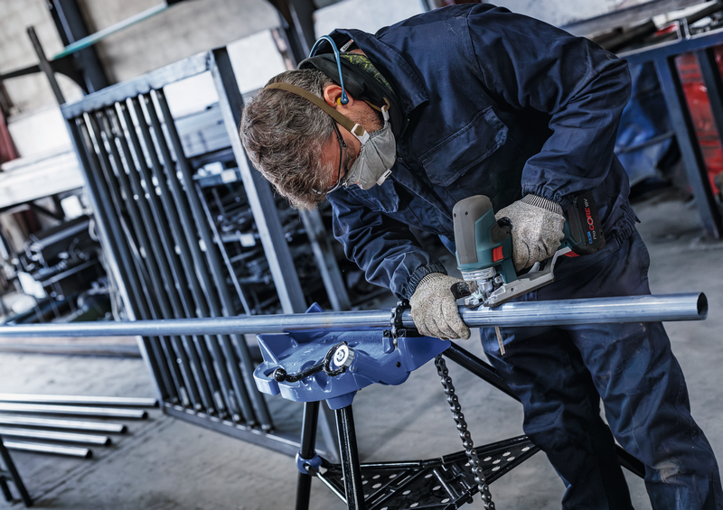 Professional using Bosch jigsaw with T321BF blade to cut long metal pipe, ideal for industrial metal cutting applications.