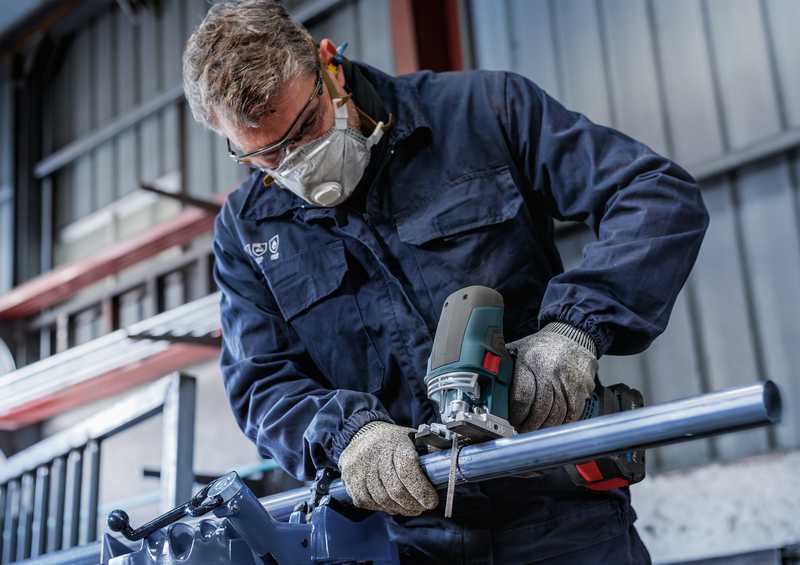 Man cutting metal pipe with Bosch jigsaw and T321BF blade, highlighting the blade’s effectiveness in heavy-duty metalwork.
