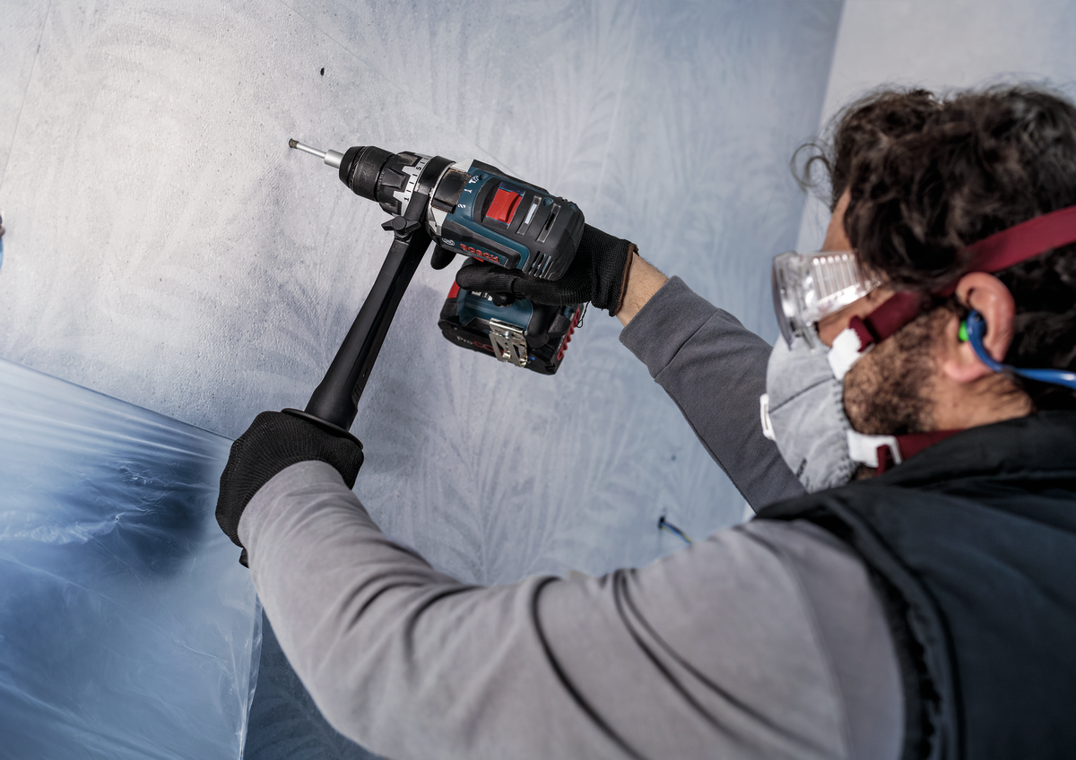 Installer using Bosch PRO Ceramic dry Drill Bit on tiled wall, demonstrating precision and ease of use in professional tile installations.