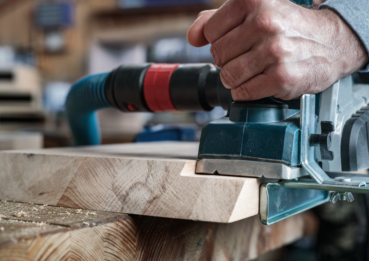 Bosch PRO Planer Knife, 82 x 29 x 3 mm 2608635905 in action, planing wood surface with precision and clean finish using power planer.