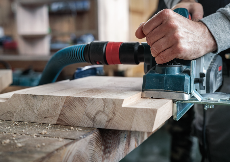 Bosch PRO Planer Knife, 82 x 29 x 3 mm 2608635905 delivering smooth cuts on wood surface during planing process in woodworking setup.