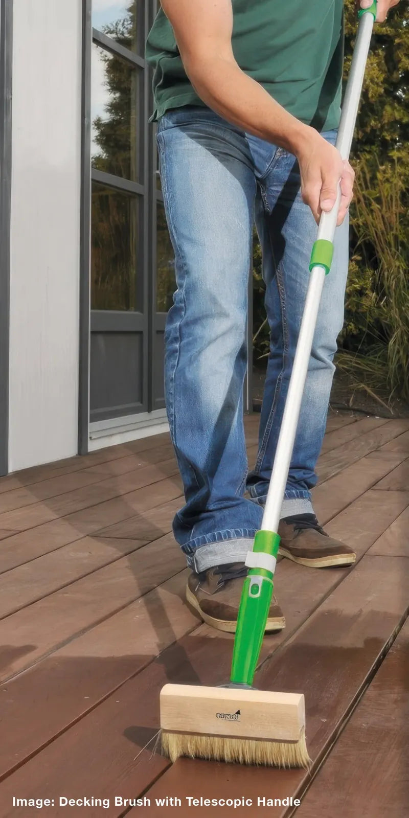 Applying Osmo Decking Oil along the boards with the Osmo decking brush on a telescopic handle