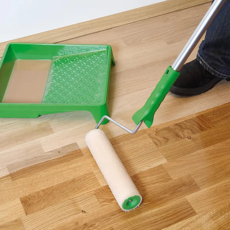 Applying Osmo oil to a wooden floor with the Osmo microfibre floor roller